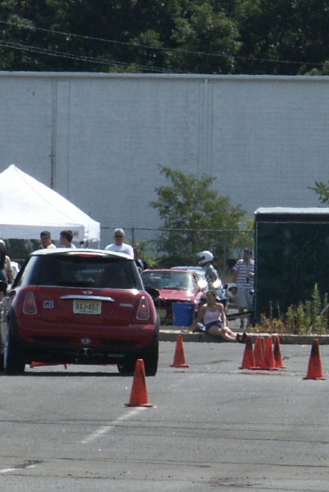 2001 Mercury Grand Marquis - A red Mini Cooper is parked on a paved surface with orange cones around it, suggesting a driving event.