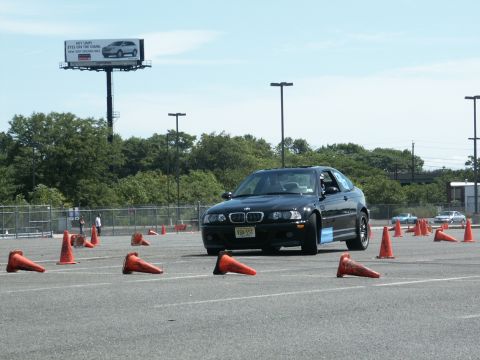 2001 Mercury Grand Marquis - Black BMW M3 E46 on an autocross course, marked by orange cones.