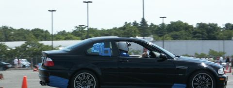 2001 Mercury Grand Marquis - A black coupe with a driver in a helmet navigates a course marked by orange cones.