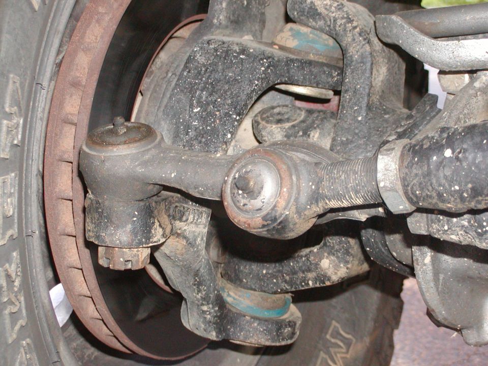 Front suspension steering knuckle, tie rod end, and brake rotor close-up