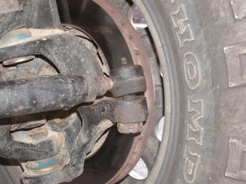 1991 Ford Bronco - This image shows the steering and suspension components of a vehicle, including a tie rod end and brake rotor.
