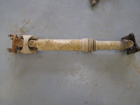 1993 Ford Bronco - A single driveshaft is shown from a side angle on a concrete surface.