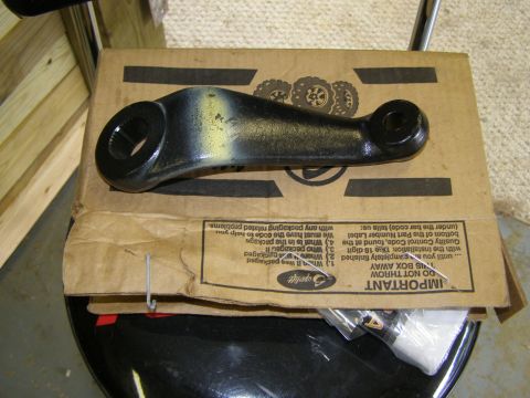 1993 Ford Bronco - A black steering linkage part with yellow markings sits on top of a cardboard box with shipping instructions.