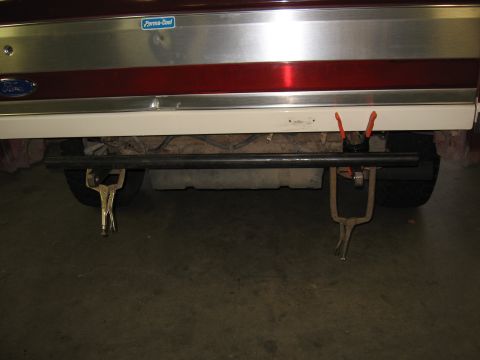 1991 Ford Bronco - Clamps are used to hold a metal bar in place during rear bumper fabrication on a vehicle.