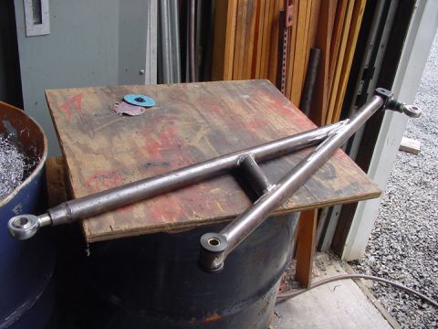 1979 Ford Bronco - A custom-fabricated traction bar rests on a wooden surface next to a barrel filled with metal shavings.