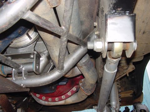 1979 Ford Bronco - Close-up of custom exhaust and suspension components, focusing on the underside of a vehicle.