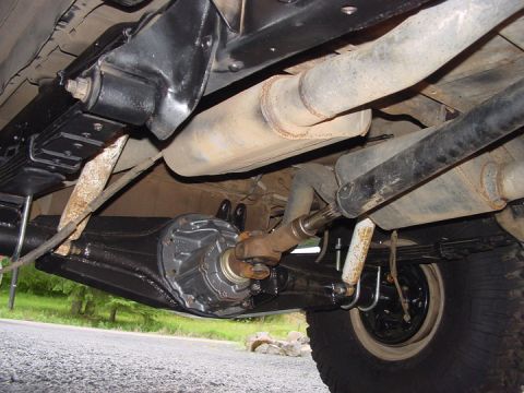 1979 Ford Bronco - Rear axle and suspension components visible from underneath a vehicle.