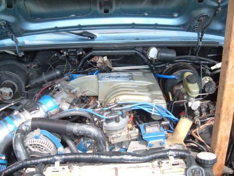 1990 Ford Ranger - Close-up view of a V8 engine bay, showing various components and blue-accented hoses.