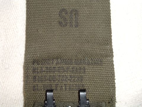 1995 Mercury Grand Marquis - Close-up of a green canvas strap marked with 'US' and other unreadable text, metal clasps at the bottom.