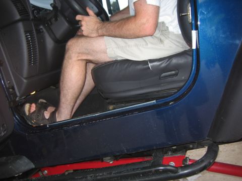 2001 Jeep Wrangler - Interior view of a blue Jeep, focusing on the driver's seat and controls.