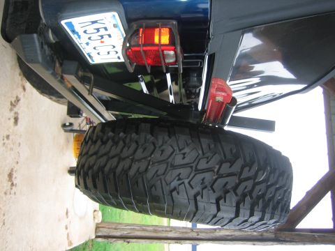 2001 Jeep Wrangler - The rear of a blue Jeep Wrangler is shown, a spare tire and a license plate.