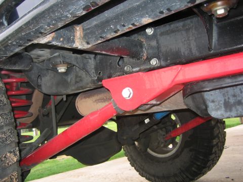 2001 Jeep Wrangler - Undercarriage view of a 2001 Jeep Wrangler, highlighting red suspension modifications.