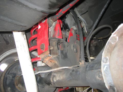 2001 Jeep Wrangler - Rear axle and suspension components, including a coil spring and red bracket, are visible.