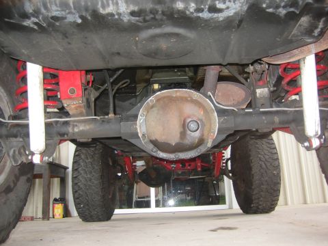 2001 Jeep Wrangler - Close-up of rear axle and suspension parts, showing differential, shocks, and springs.