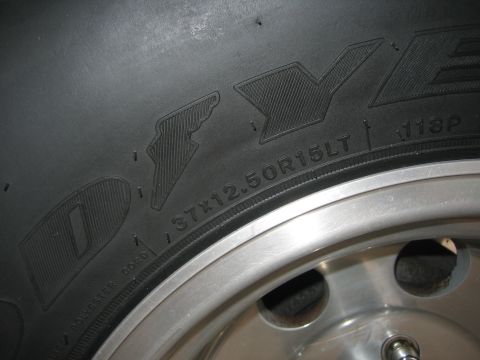 2001 Jeep Wrangler - Close-up of a tire sidewall marked 37x12.50R15LT 118P mounted on a polished aluminum wheel.
