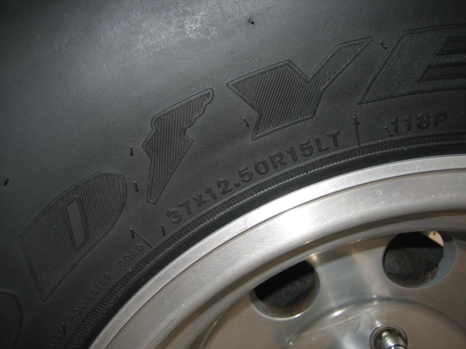 Tire sidewall close-up showing size 37x12.50R15LT marking on an aluminum wheel