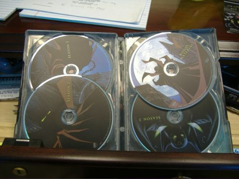 1991 Ford Bronco - A DVD case containing multiple discs is open on a desk, with papers in the background.