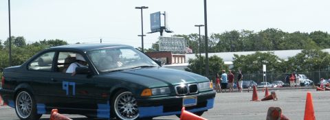 2001 Mercury Grand Marquis - A green BMW coupe, marked with the number 97 and blue tape, participates in an autocross event.