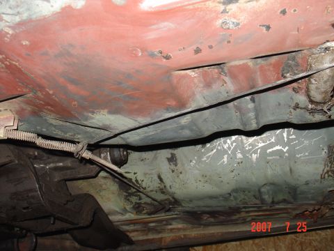 1973 Ford Ranchero - Close-up of a vehicle's underbody, revealing rust and a brake cable. The image is dated July 25, 2007.