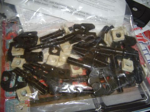 1978 Ford Bronco - A collection of metal hardware, including bolts and square nuts, is packaged in plastic.