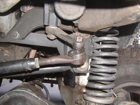 1991 Ford Bronco - Undercarriage view of steering linkage and suspension components.
