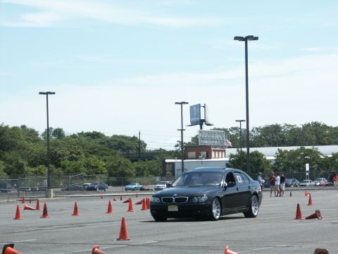 2001 Mercury Grand Marquis - BMW sedan competes in an autocross event on a sunny day, with cones marking the course.