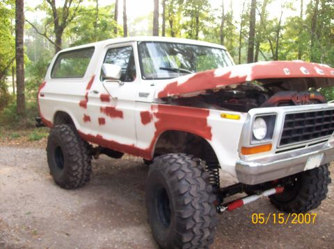 1978 Ford Bronco - This 1978 Ford Bronco is undergoing bodywork, with primer visible on the exterior panels and the hood raised.