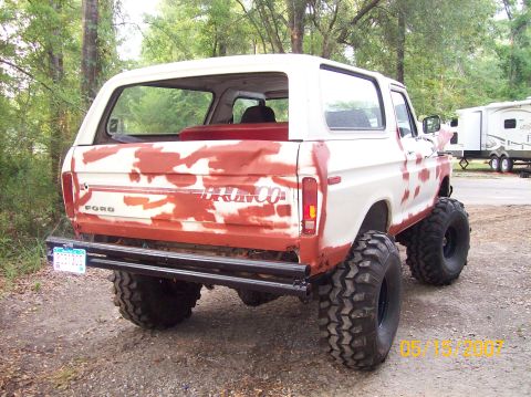 1978 Ford Bronco - This 1978 Ford Bronco is undergoing a paint job, showing red primer patches over its white body and large off-road tires.