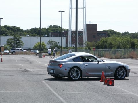 2001 Mercury Grand Marquis - A silver BMW coupe navigates a course marked by traffic cones in an open lot.