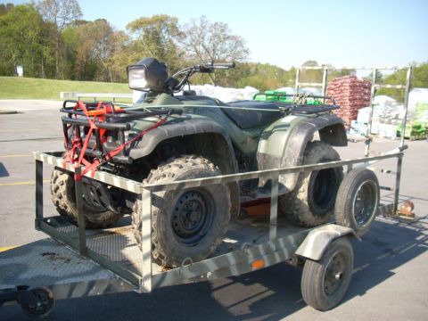 1999 Honda FOURTRAX FOREMAN S - An all-terrain vehicle is transported on a utility trailer.