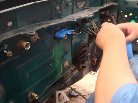 1993 Ford Taurus - Working on the wiring harness on a car's firewall during a rebuild.