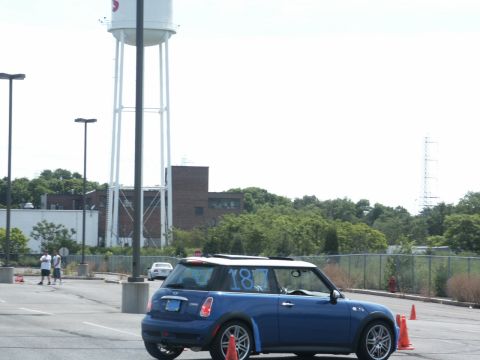 2001 Mercury Grand Marquis - A blue Mini Cooper is parked on an asphalt lot, with orange cones visible around it.