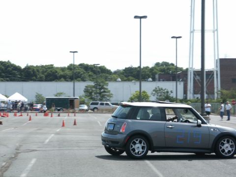 2001 Mercury Grand Marquis - A gray Mini Cooper navigates a course marked by orange cones in a parking lot.