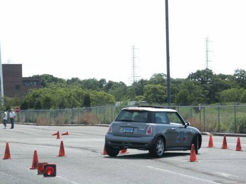 2001 Mercury Grand Marquis - A gray Mini Cooper navigates an autocross course marked by orange cones.