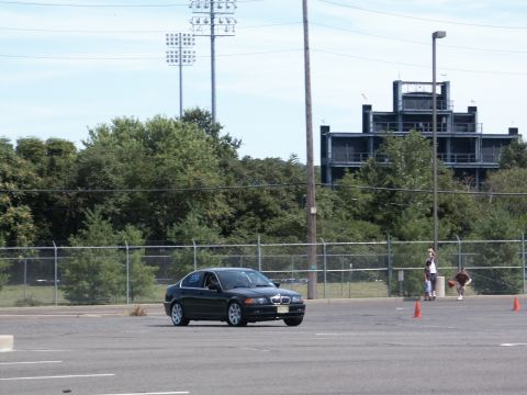 2001 Mercury Grand Marquis - A BMW 3 Series sedan navigates a course marked by orange cones on a sunny day.