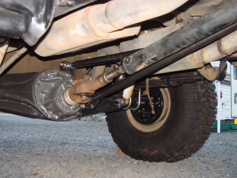 1979 Ford Bronco - A close-up view of the rear axle and suspension components of a vehicle, including a traction bar.