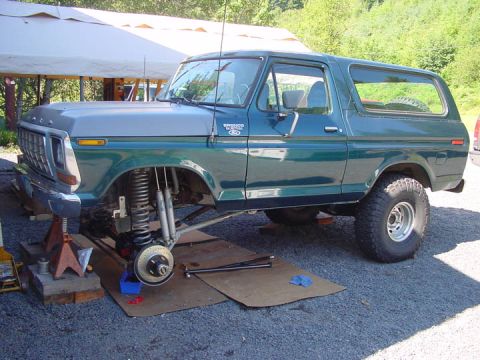 1979 Ford Bronco - This 1978 Ford Bronco is undergoing front suspension work, with the wheel and brake assembly exposed.