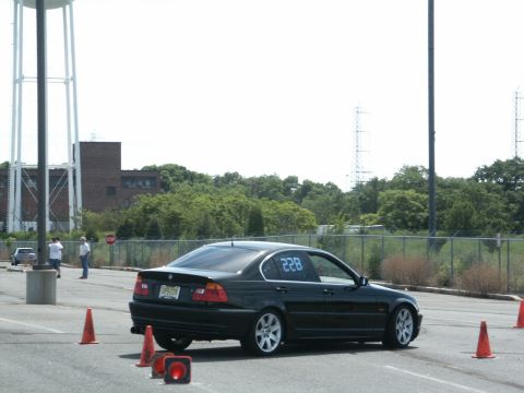 2001 Mercury Grand Marquis - A black sedan with the number 228 displayed on its window navigates a course marked by orange cones.