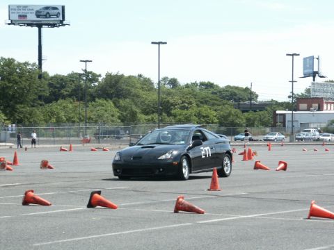 2001 Mercury Grand Marquis - Black sports car navigates an autocross course marked by orange cones.