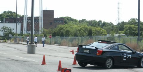 2001 Mercury Grand Marquis - A black coupe with racing numbers is parked on a lot with orange cones.