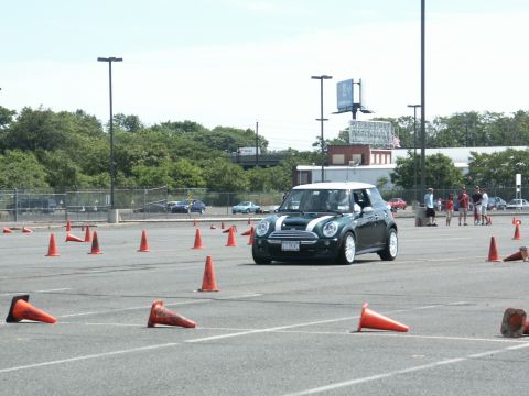 2001 Mercury Grand Marquis - A Mini Cooper S navigates a cone course on a sunny day.