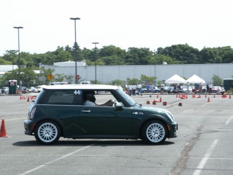 2001 Mercury Grand Marquis - A green Mini Cooper navigates an autocross course marked with orange cones.