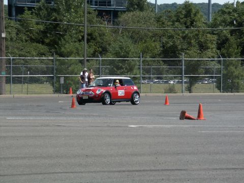 2001 Mercury Grand Marquis - A red Mini Cooper navigates an autocross course marked by orange cones.
