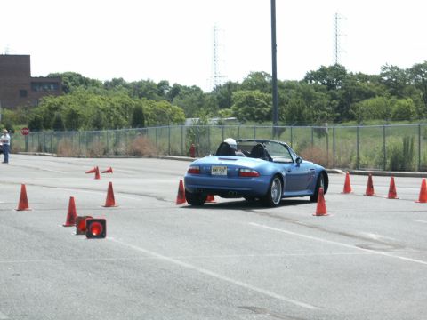 2001 Mercury Grand Marquis - A blue convertible navigates an autocross course marked by orange cones.