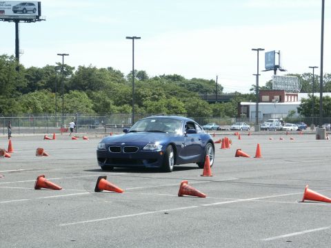 2001 Mercury Grand Marquis - Blue BMW Z4 coupe on a cone course during an event.