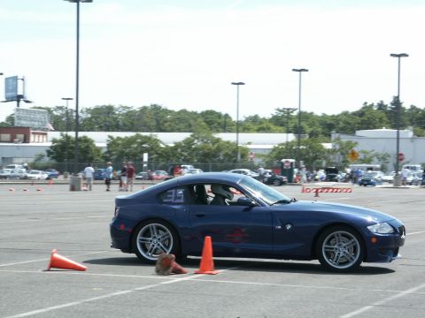 2001 Mercury Grand Marquis - A blue coupe is parked on an asphalt lot, with orange cones and people in the background.