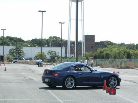 2001 Mercury Grand Marquis - A blue coupe with racing number 35 is visible in a parking lot with orange cones and other vehicles in the background.