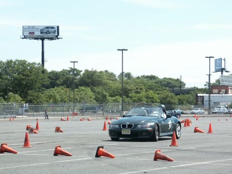 2001 Mercury Grand Marquis - A dark green BMW Z3 convertible is seen on an autocross course, marked with racing number 31.