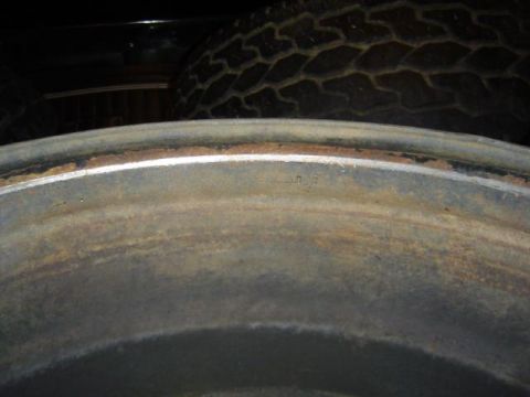 1979 Ford Bronco - Close-up of a rusty wheel rim and a tire.