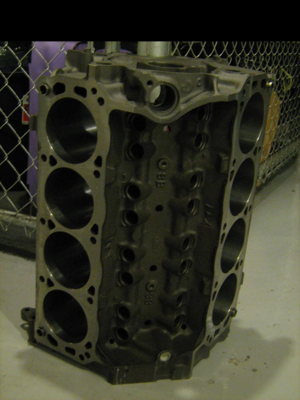 Bare V-engine block standing upright showing both cylinder banks